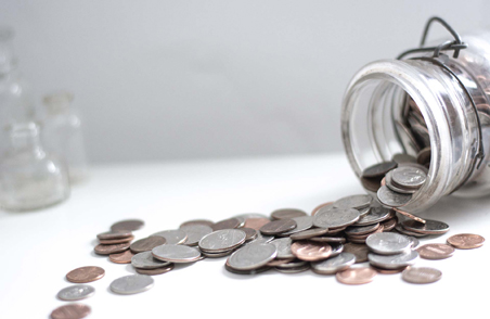 Coins spilling from jar — payment plans available